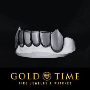 Side view of black fang grill on a black background with 'Gold Time' branding.