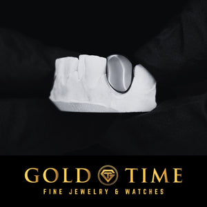 Silver single tooth grillz cap fitted to a lower dental mold, Gold Time