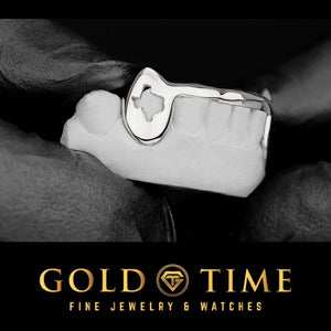 Silver grillz with a Texas-shaped cut out fang on a hand with 'Gold Time' branding at the bottom.