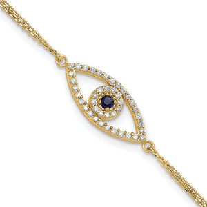 Close view of the yellow gold evil eye charm with a diamond outline around a blue sapphire