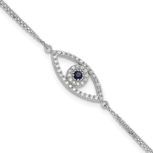 Close view of the white gold evil eye charm with a diamond outline around a blue sapphire
