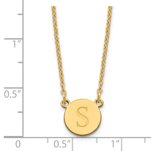 Yellow gold initial circle necklace beside a ruler, disc about 10mm by 12mm