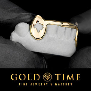 Yellow gold fang grillz with a Texas shaped cut out on a dental mold held in a gloved hand, Gold Time