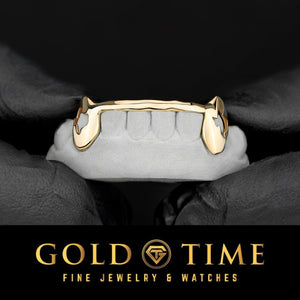 Yellow gold 6 piece grillz with Texas cut out fangs and a solid tip bar on a dental mold held in gloved hands, Gold Time