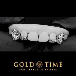 Silver 4 piece grillz on a dental model with trillion cut incisor tips and diamond dust canines, on black with the Gold Time logo