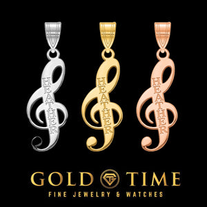 Treble clef name pendants in silver, yellow gold and rose gold on black with the Gold Time logo