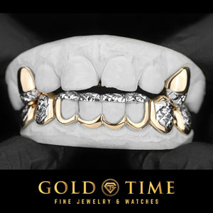 Custom 10 piece two-tone grillz on a mold: 2 yellow gold top fangs with white diamond-cut tips and an 8 piece yellow gold open window bottom