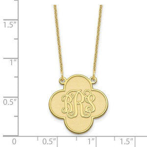 Yellow gold clover monogram pendant measured against a ruler at about three quarters of an inch across