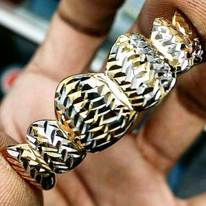 Hand holding two-tone pineapple diamond cut grillz up close