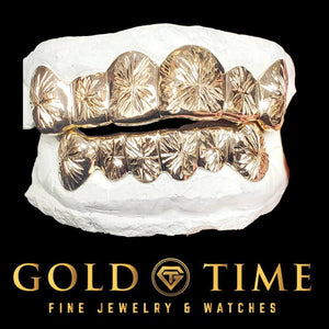 Two tone gold 12 piece starburst cut grillz set, six top and six bottom, fitted to dental molds