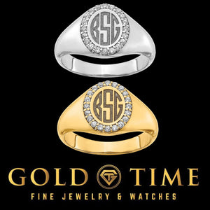White gold and yellow gold oval monogram signet rings with diamond halos shown together
