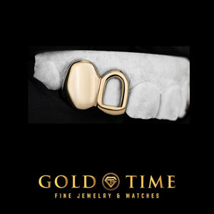 Yellow gold double cap with a solid canine and open face incisor on a dental mold