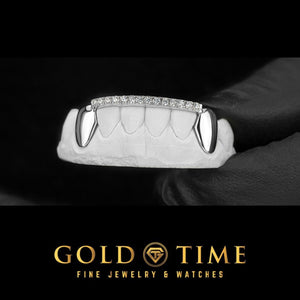 White gold six piece bottom grillz with solid canine caps and a row of moissanite along the front tips, on a dental model