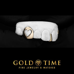 Gold heart cut-out canine cap and slim gap bar grillz on a top mold