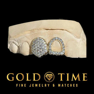 Yellow gold double cap grillz with one fully bustdown moissanite tooth and one open face cap with a moissanite border on a dental mold
