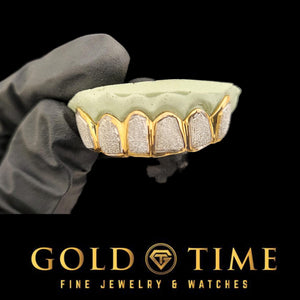 Gloved hand holding a mold with the 6 piece gold framed diamond dust box grill