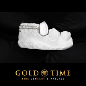 Side view of solid canine fang grillz with a moissanite center row on a mold