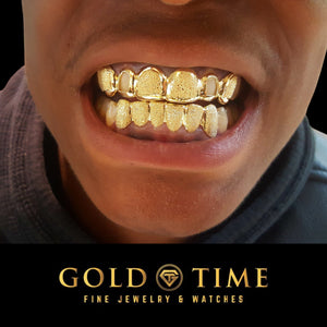 Yellow gold 6 piece diamond dust grillz worn across the top teeth