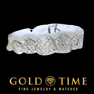 Silver 6 piece trillion cut and diamond dust grillz viewed from an angle on a dental model