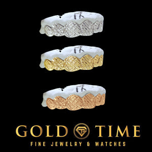 The 6 piece trillion cut grillz shown in silver, yellow gold and rose gold on black