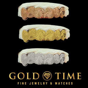 The Polynesian tribal engraved 6 piece grillz shown in rose gold, yellow gold and silver on black