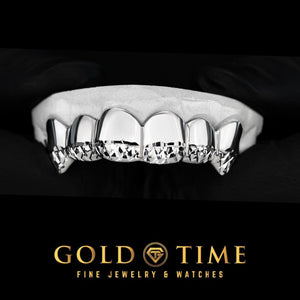 White gold six piece grillz with trillion cut tips and fangs on a dental model