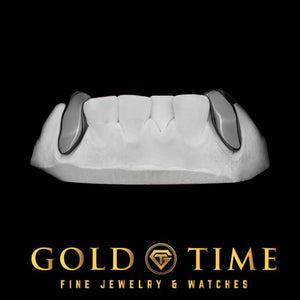Two solid black canine caps seated on a white dental model, joined by a bar behind the front teeth