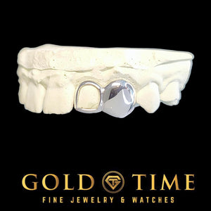 White gold double cap grillz with a solid canine and open face incisor on a dental mold