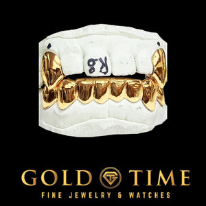 Yellow gold 10 piece solid grillz set with canine fangs fitted to top and bottom dental molds
