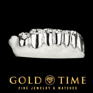 Side view of silver 8 piece lower grillz with trillion diamond cuts and diamond dust tips on a dental mold, Gold Time