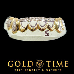 8 piece yellow gold open window bottom grill with white gold diamond-cut outer teeth on a dental mold