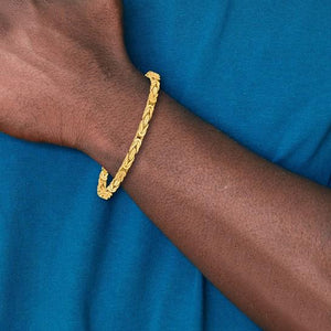 10K gold Byzantine bracelet worn on a wrist with a blue shirt