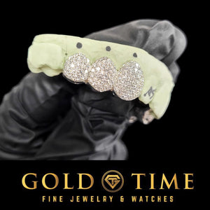 Angled view of the three piece honeycomb bustdown moissanite grillz on a mold held in a gloved hand