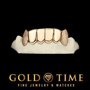 Six piece grill with polished perm cut fronts and diamond dust fang canines on a dental mold