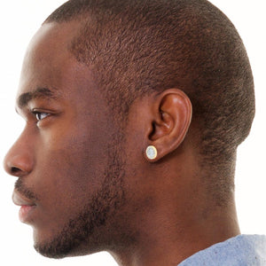 Man wearing a round diamond halo stud earring