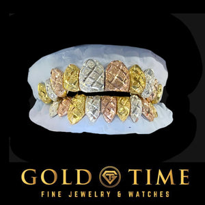 Full tri-color top and bottom grill set in yellow, white, and rose with crosshatch diamond-cuts on a dental mold