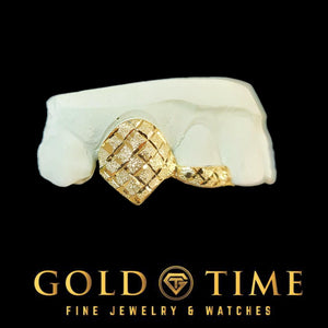 Gold grillz with diamond-cuts and dust on a white block against a black background, featuring 'Gold Time' branding.