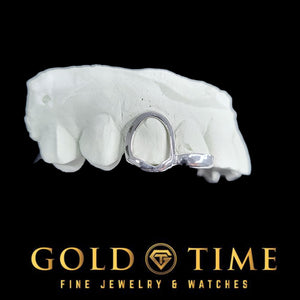 White gold open face cap fitted to a dental mold, seen from the front