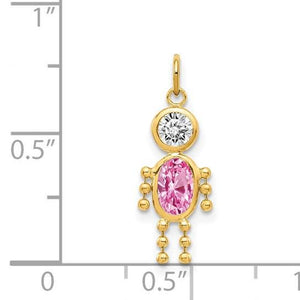 Gold boy charm with pink birthstone shown next to a ruler for size reference