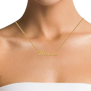 Woman wearing a dainty gold script name necklace at the collarbone