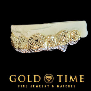 Side view of custom two-tone trillion cut fang grillz