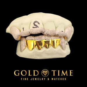 Diamond dust canine grillz with a matching top piece on a mold