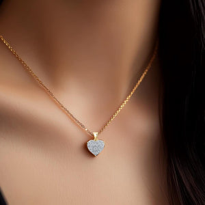Woman wearing the 10k gold diamond heart pendant on a fine chain