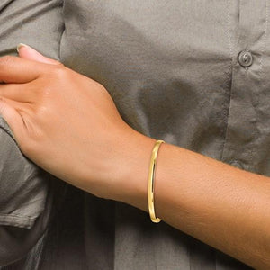 14K gold 4mm slip on bangle worn on a wrist