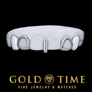 White gold solid canines, open face incisors and gap bar grillz on a mold