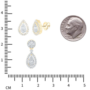 Diamond teardrop earrings and pendant next to a ruler and a dime for scale