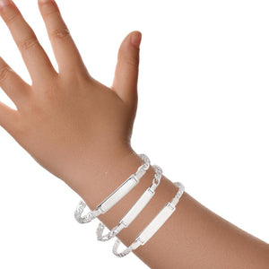 Child's wrist wearing three sterling silver ID bracelets