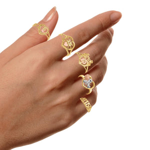 Hand wearing four different 10K gold quinceanera rings to compare the designs