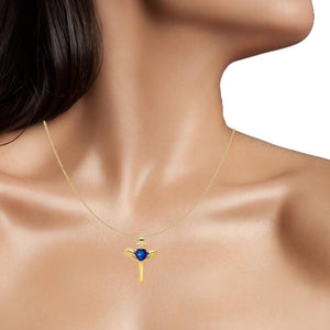 Woman wearing a 14K yellow gold Claddagh cross pendant with a blue heart stone
