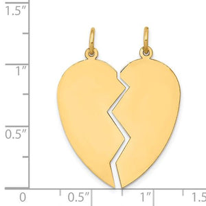 Yellow gold broken heart pendant measured against a ruler at about one and a quarter inches tall